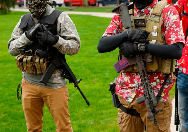 Armed protesters guard demonstrators at the Michigan State Capitol in April 2020.