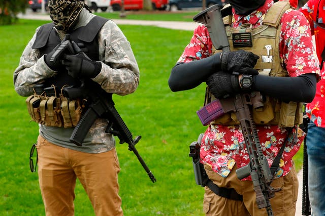 Armed protesters guard demonstrators at the Michigan State Capitol in April 2020.