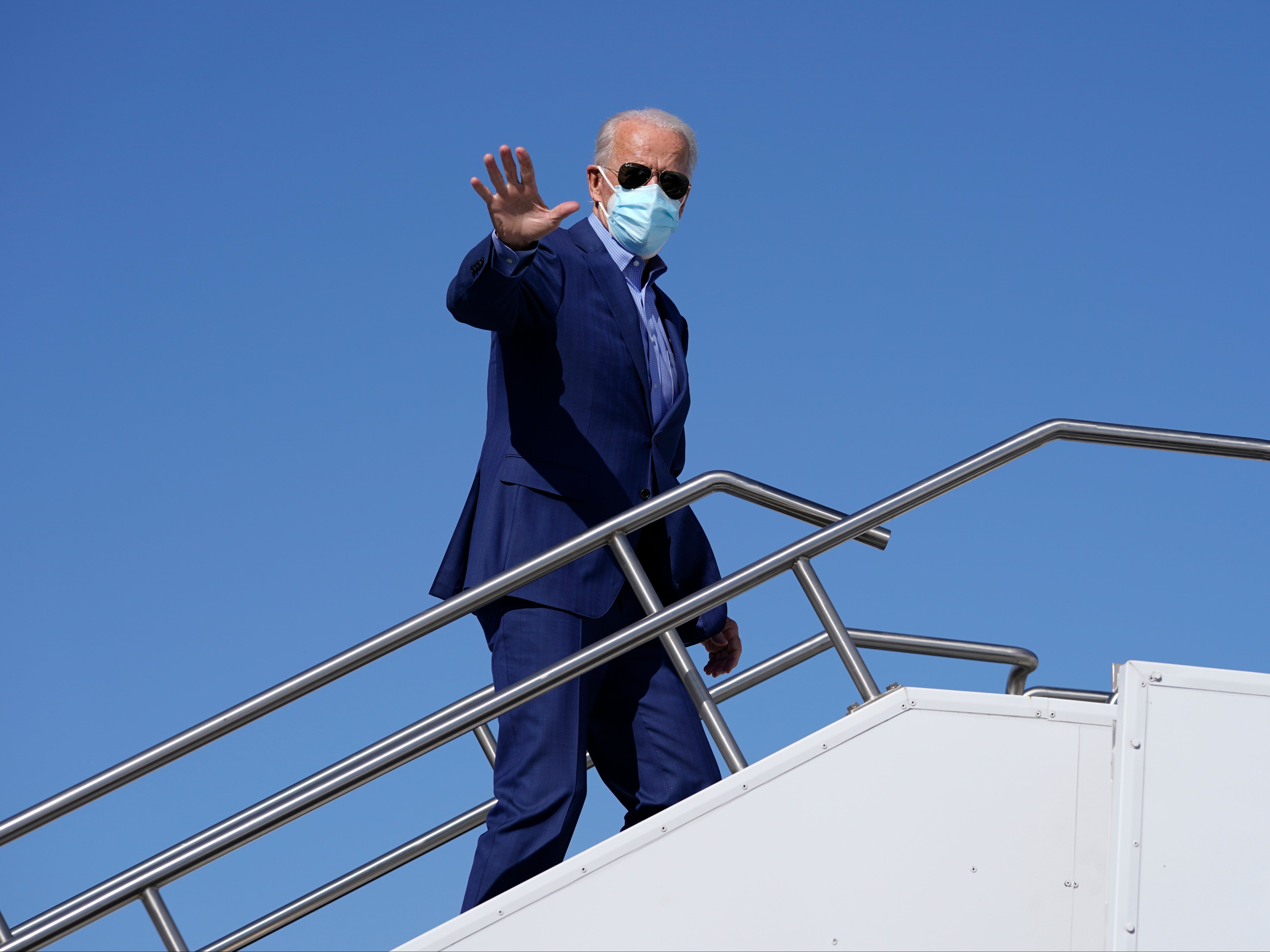 Democratic presidential candidate former Vice President Joe Biden waves as he boards his campaign plane in Phoenix, Friday, October 9, 2020, en route to Las Vegas