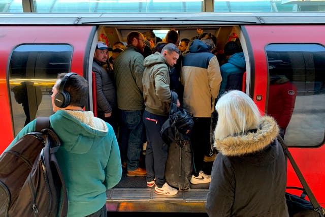 Commuters cram onto the Tube as services are reduced