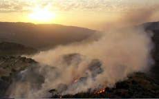 Mideast wildfires kill 2, force thousands to flee homes