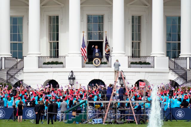 Donald Trump arrives to speak from the Blue Room Balcony of the White House to a crowd of supporters on 10 October, 2020