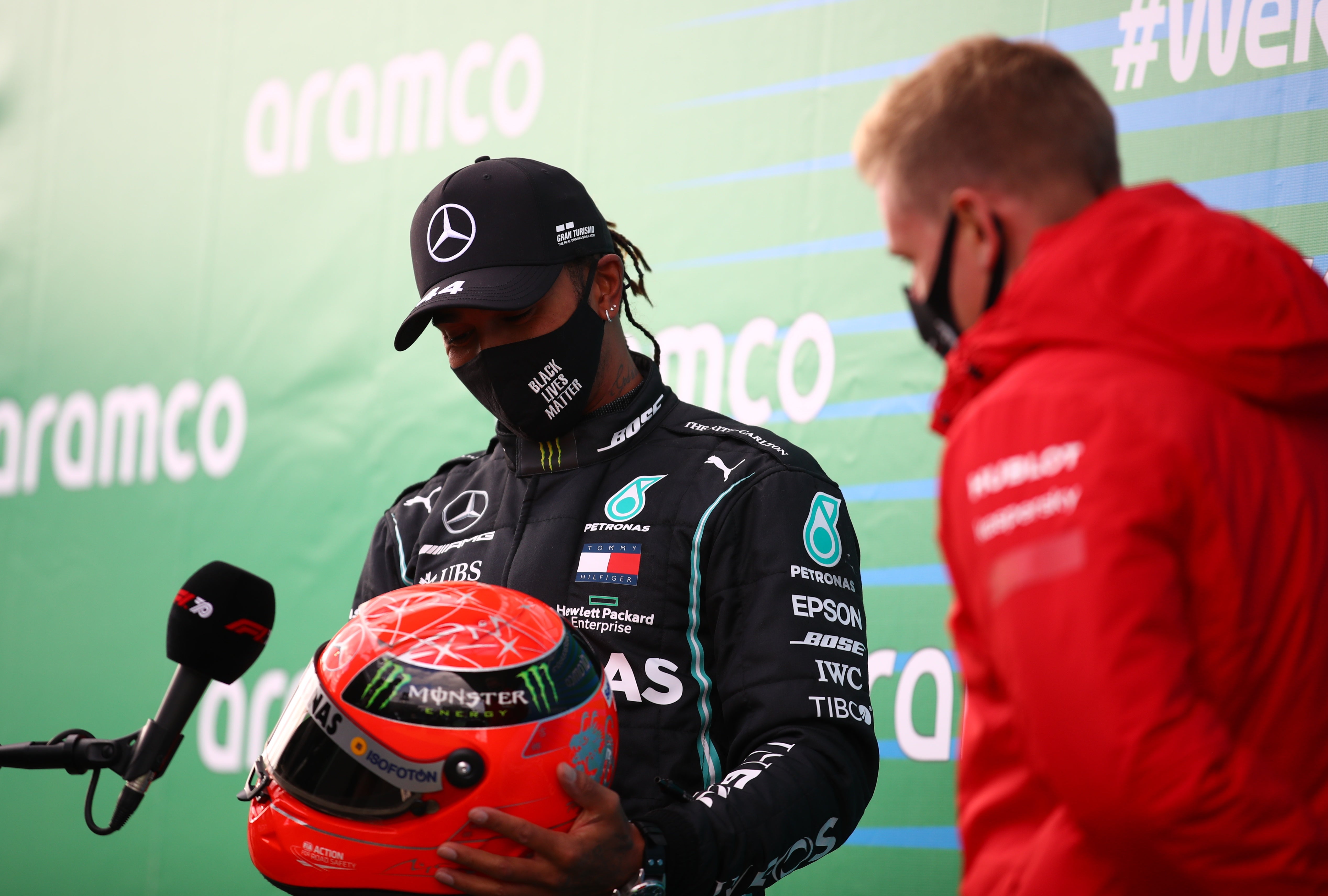 Lewis Hamilton is presented with one of Michael Schumacher’s helmets by his son Mick
