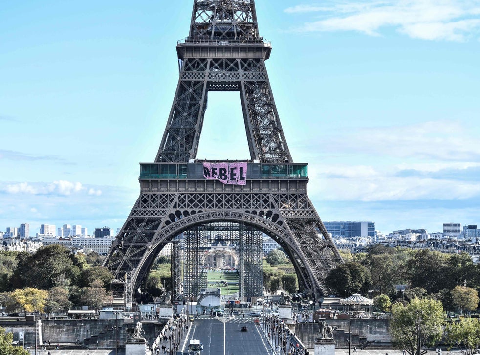 Extinction Rebellion protesters scale Eiffel Tower to unfurl 'rebel