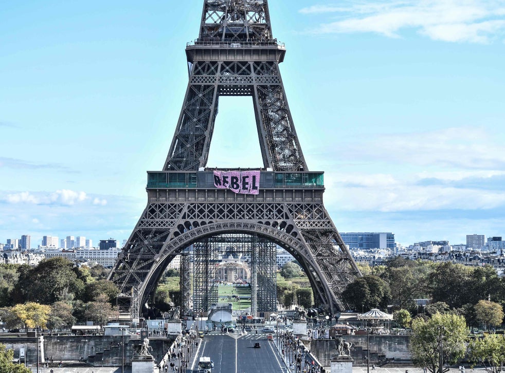 Extinction Rebellion protesters scale Eiffel Tower to unfurl 'rebel