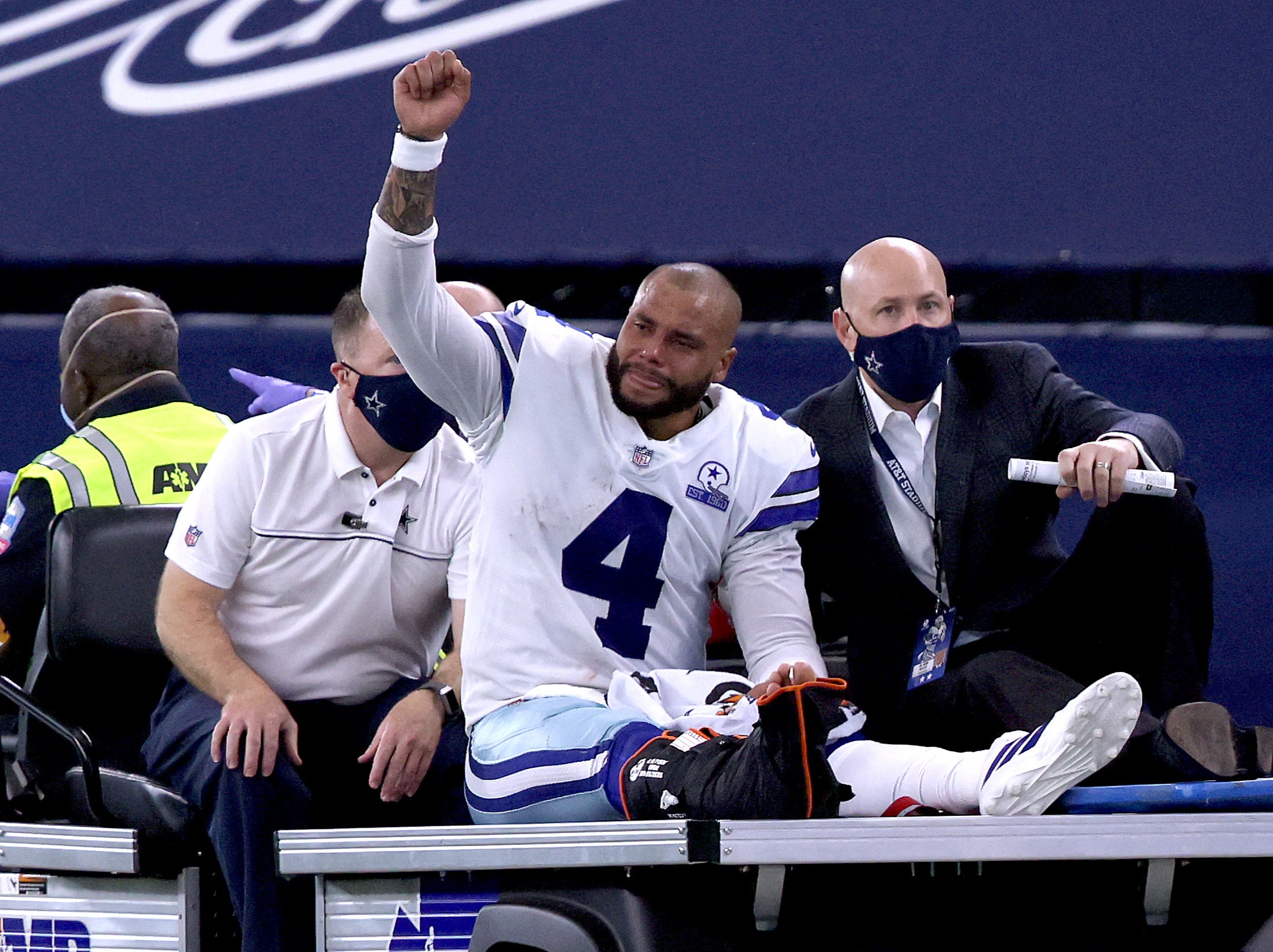 Dak Prescott of the Dallas Cowboys is helped off the field