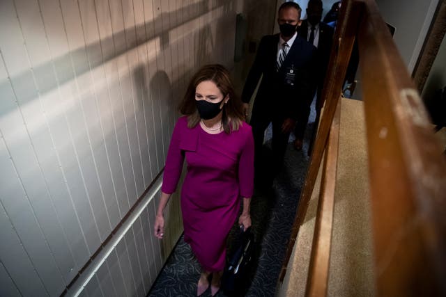 Supreme Court nominee Judge Amy Coney Barrett arrives to testify before the Senate Judiciary Committee on the first day of her Supreme Court confirmation hearing on Capitol Hill on 12 October 2020.