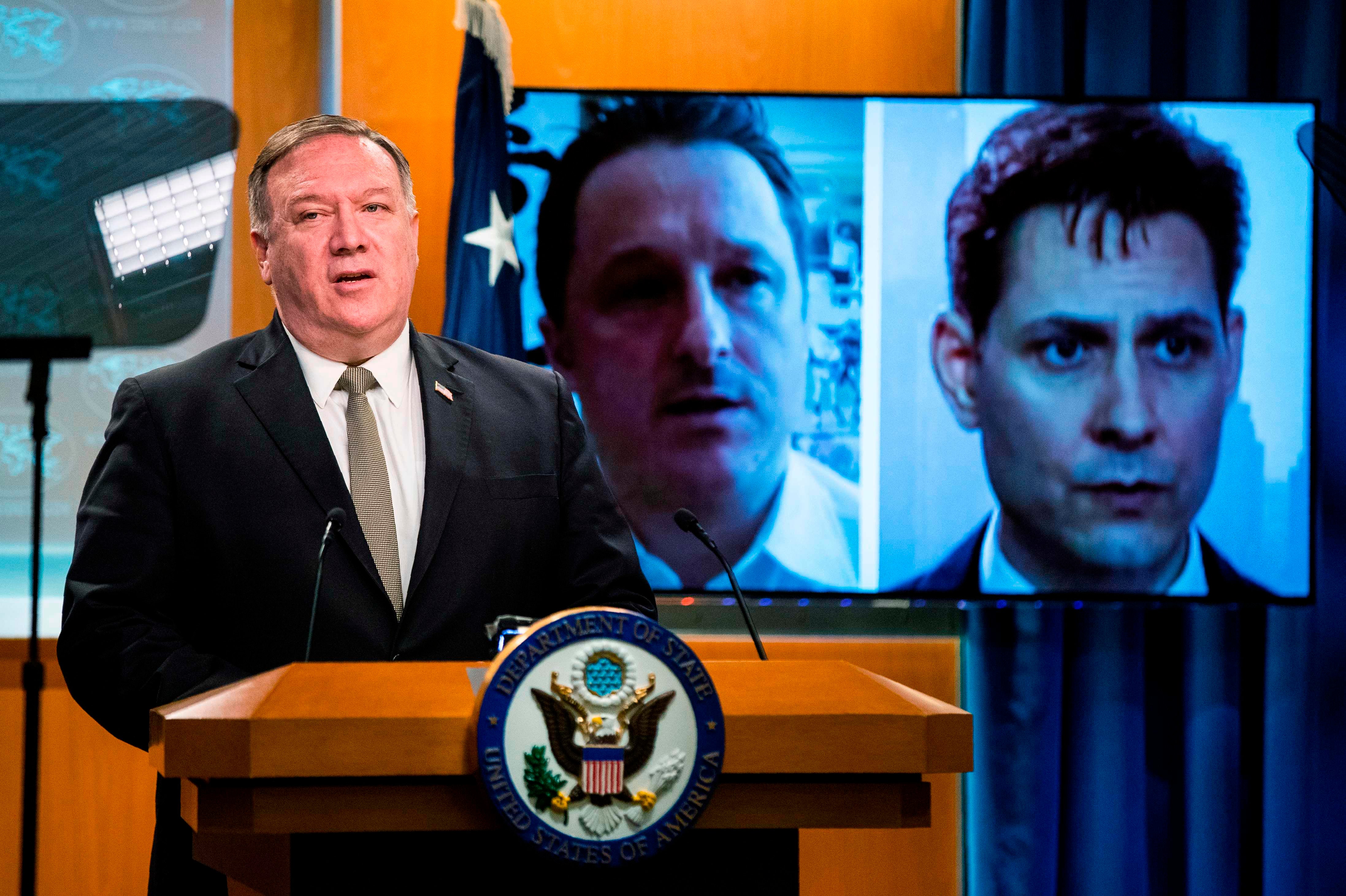 Michael Kovrig, right, seen here as Secretary of State Mike Pompeo speaks out against his detention in China