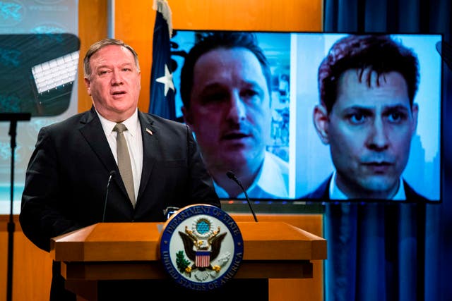 Michael Kovrig, right, seen here as Secretary of State Mike Pompeo speaks out against his detention in China