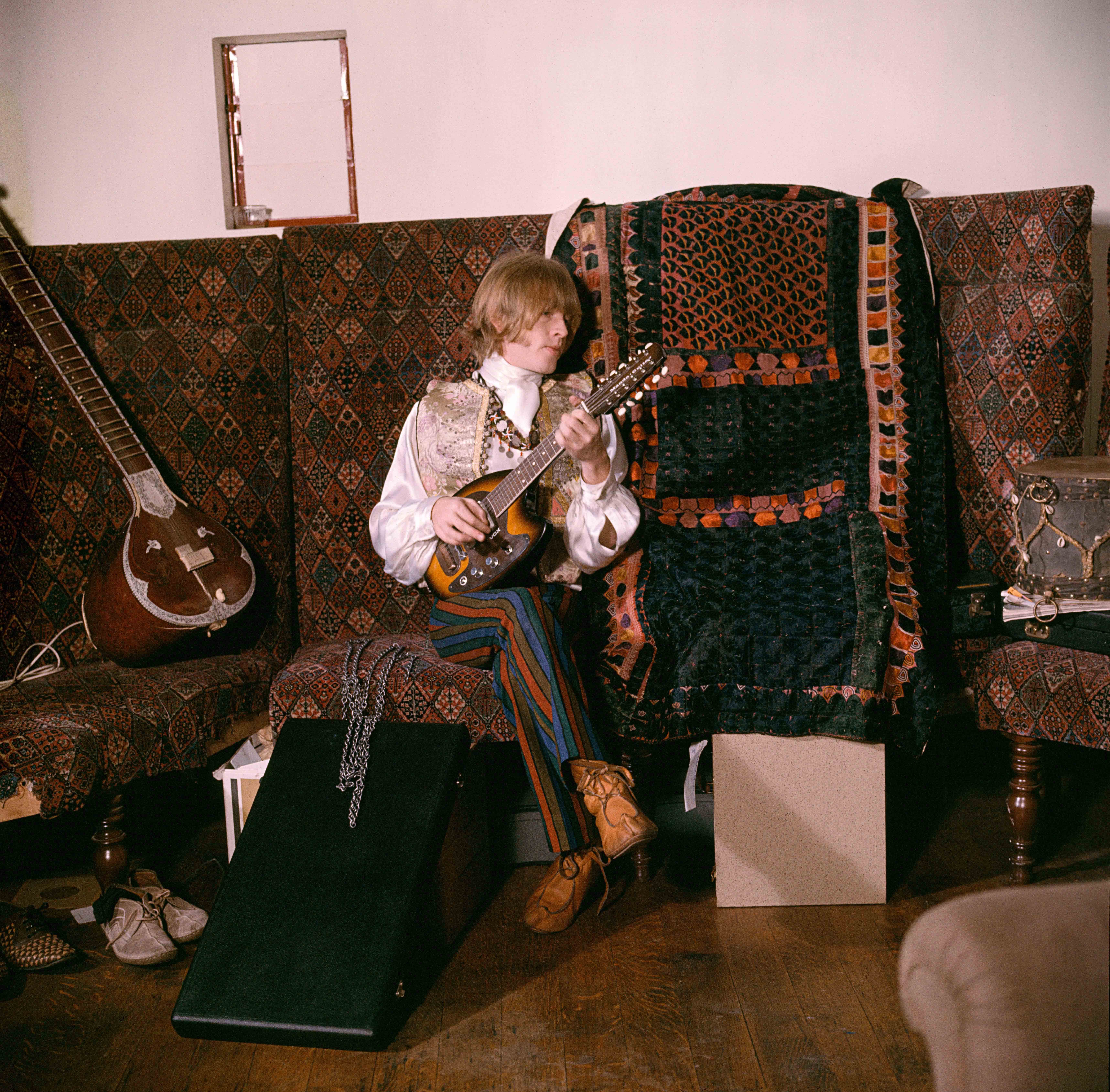 Brian Jones at home on a settee. Courtfield Gardens, South Kensington