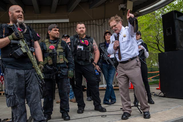 <p>Barry County Sheriff Dar Leaf, front right, speaks next to members of the Michigan Liberty Militia during the “American Patriot Rally-Sheriffs speak out” event at Rosa Parks Circle in downtown Grand Rapids, Michigan, Monday, 18 May, 2020</p>