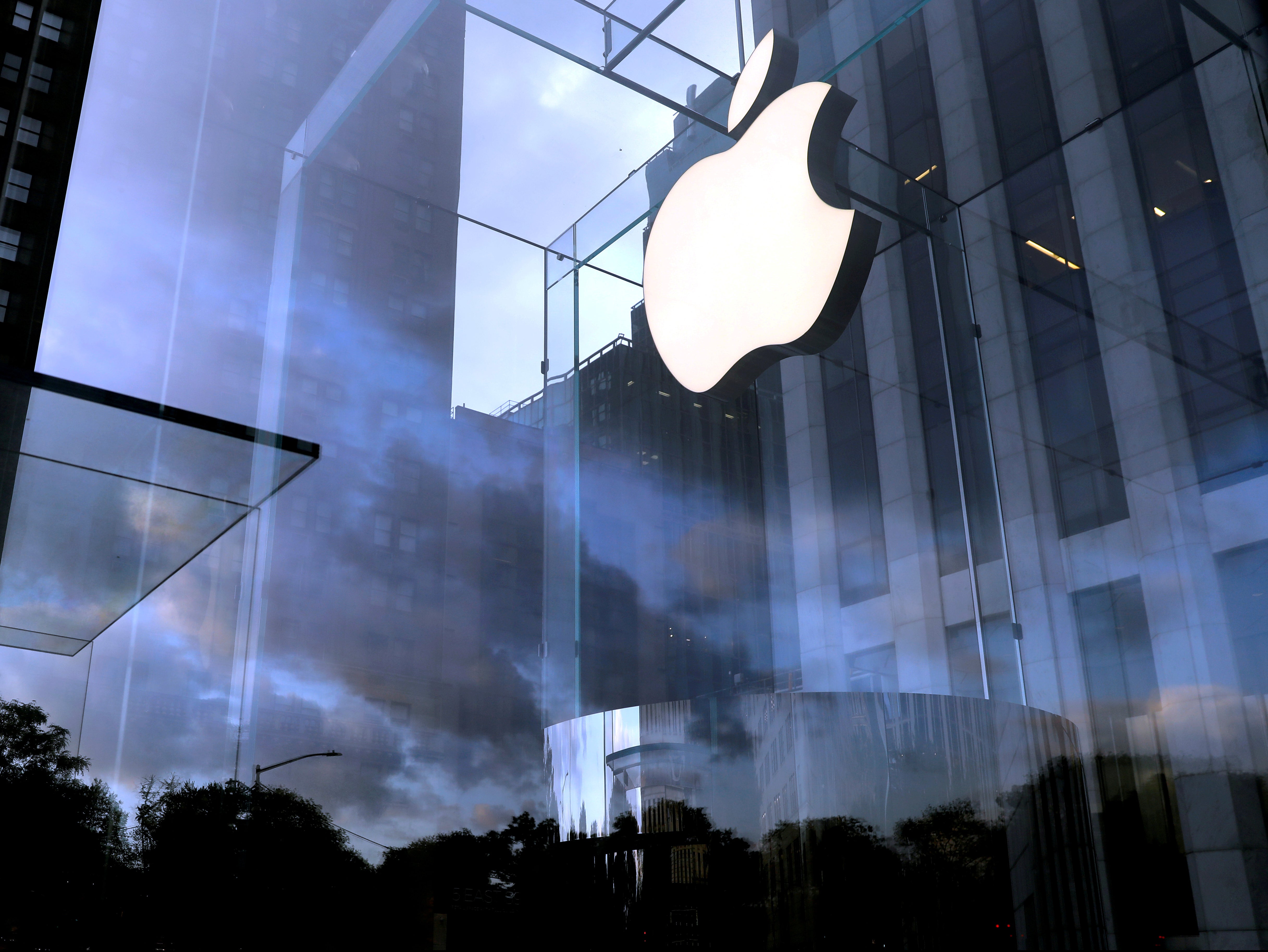 The Apple Inc. logo is seen hanging at the entrance to the Apple store on 5th Avenue in Manhattan, New York