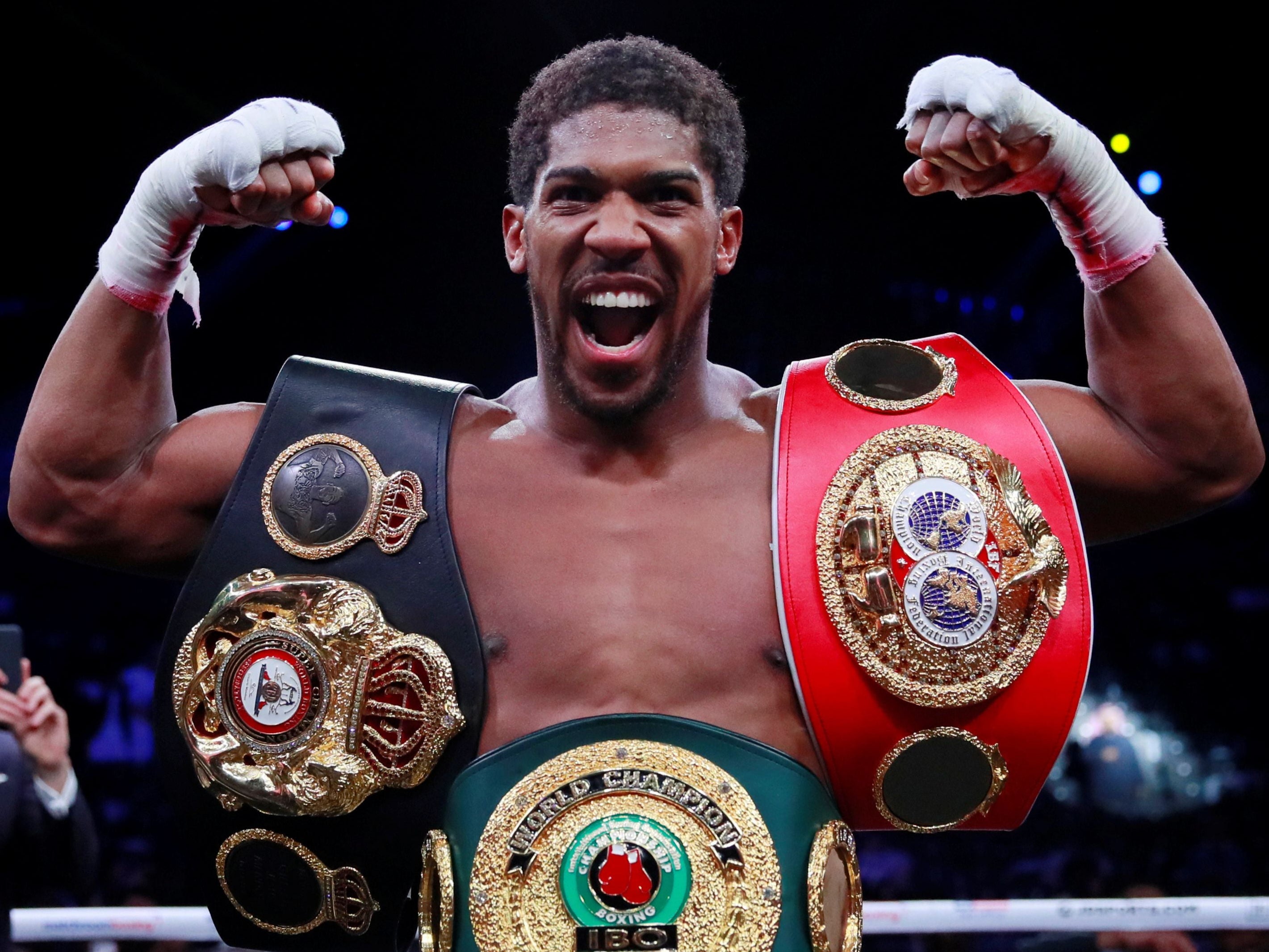 Joshua celebrates recapturing his belts after defeating Ruiz Jr