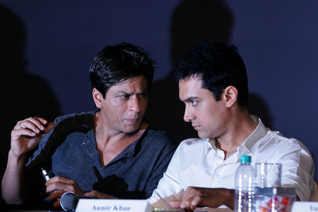 In this April 7, 2009, file photo, Bollywood actors Shah Rukh Khan, left, and Aamir Khan speak during a press conference in Mumbai