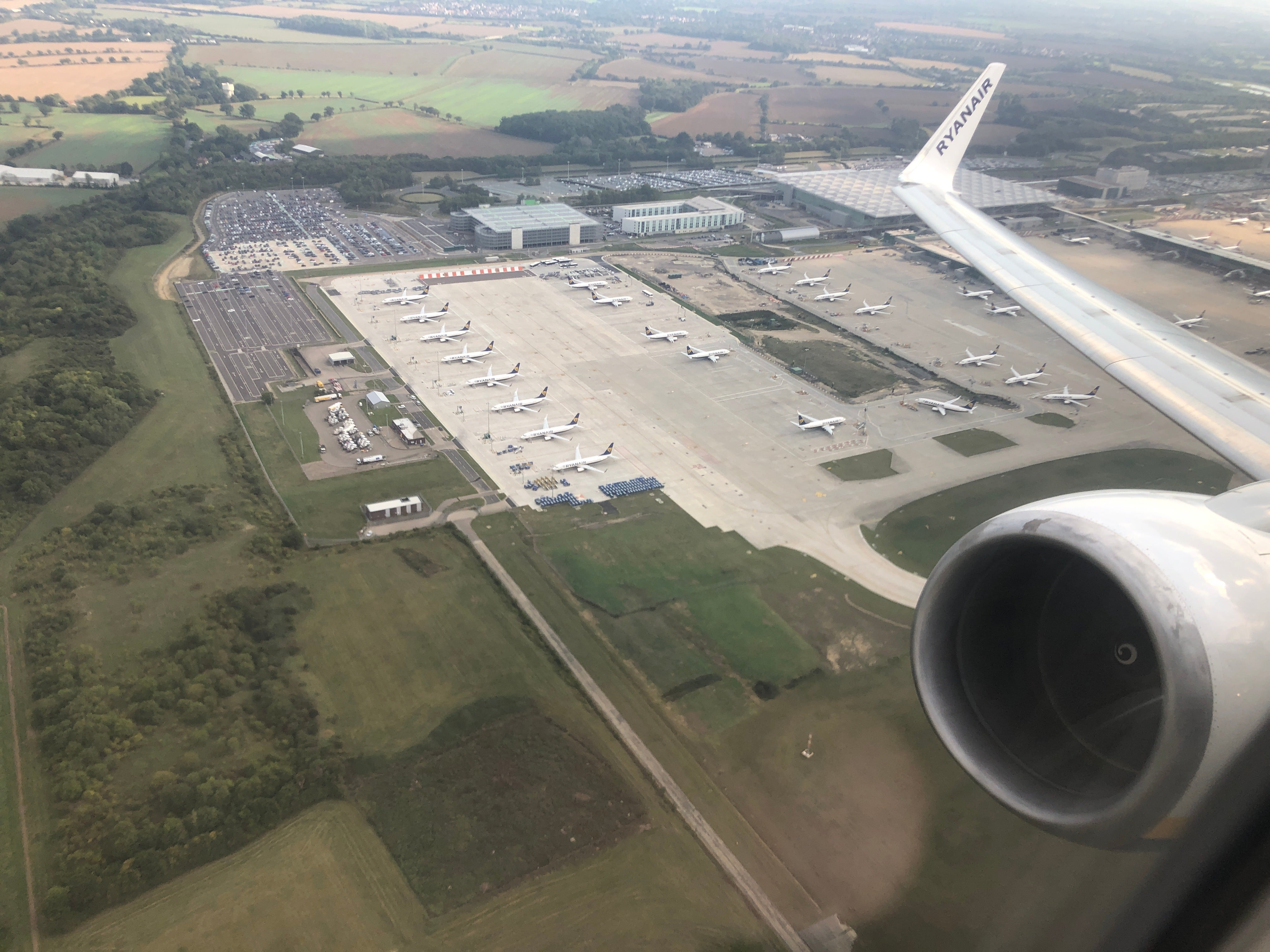 Ground stop: a Ryanair Boeing 737 flies past lines of parked aircraft at Stansted airport