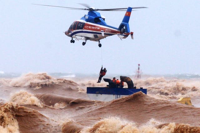 A helicopter crew rescue stranded people from waves in Quang Tri province, Vietnam, on 11 October 2020. Heavy rains and floods killed nine people and left 11 missing during the past few days