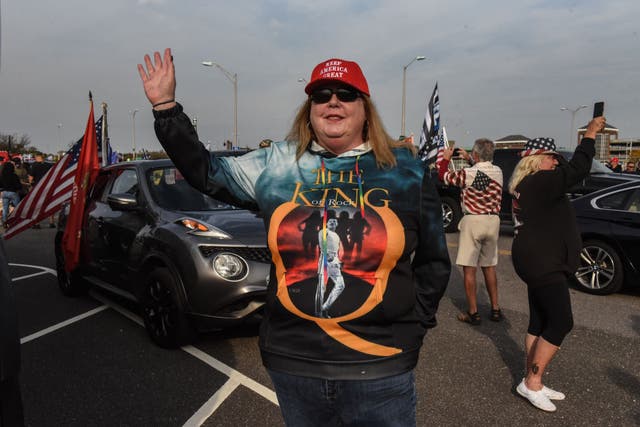A woman wearing a QAnon sweatshirt gestures during a pro-Trump rally in Ronkonkoma, New York, on 11 October 2020