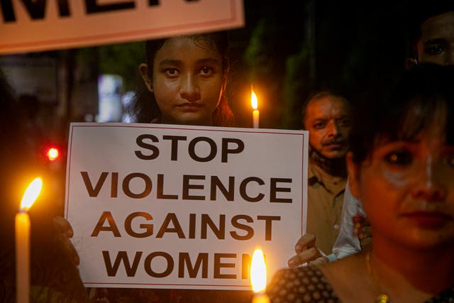 Indians hold placards as they protest against the alleged gang rape and killing of a Dalit woman in Uttar Pradesh, on Saturday 10 October, in Gauhati