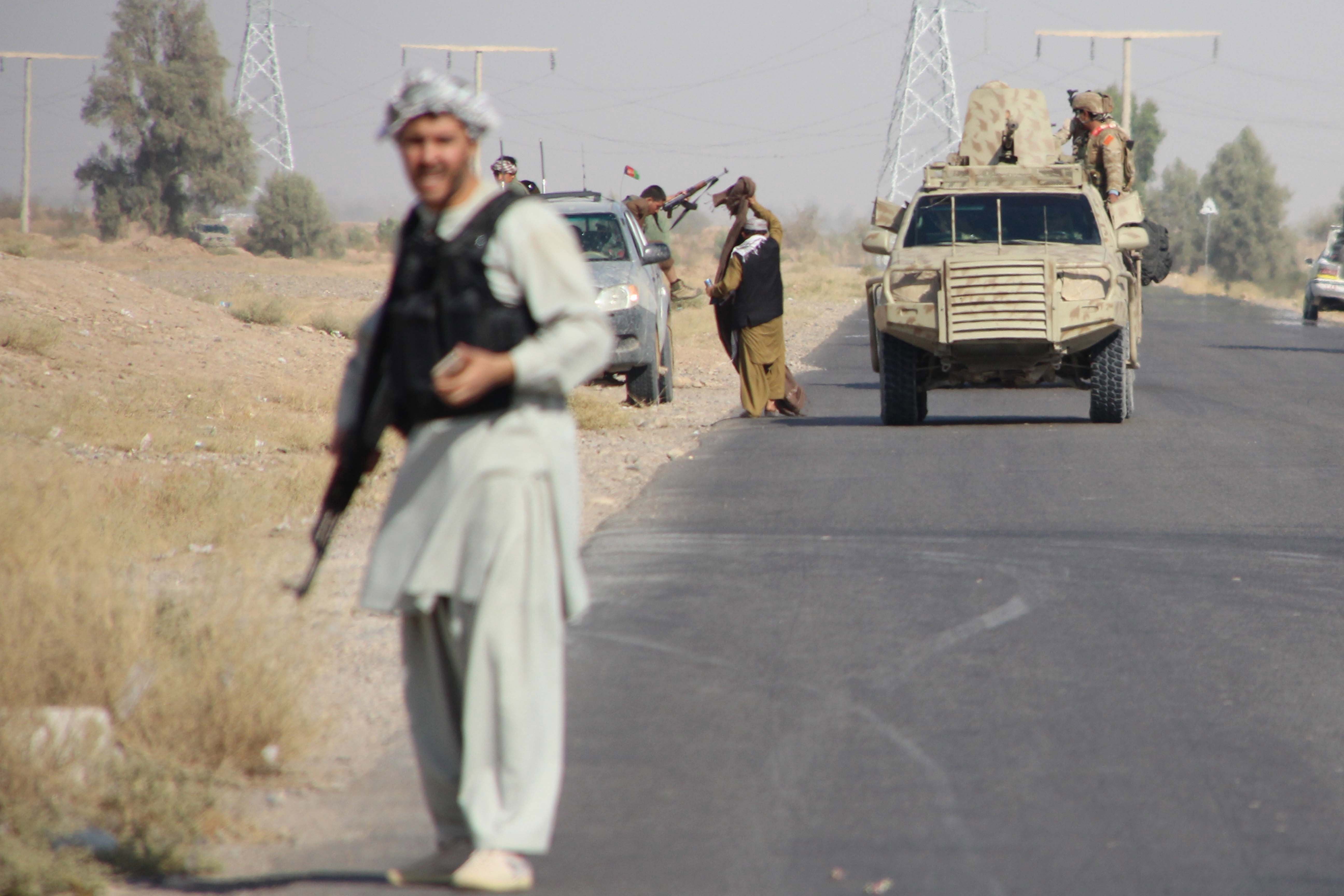 Afghan security officials and private militia patrol on Helmand-Kandahar highway