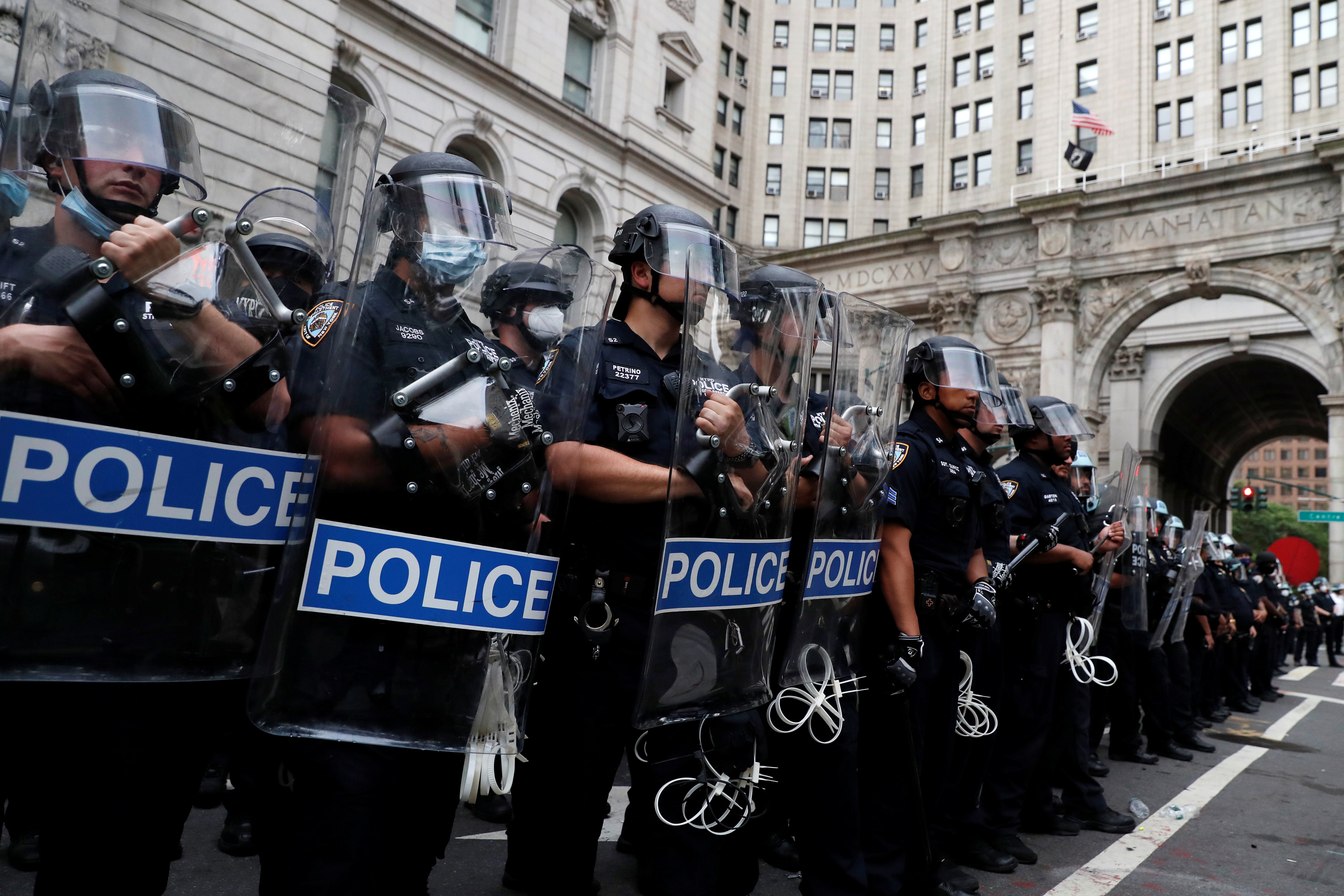 New York Police Department (NYPD) officers form a line inside of an area being called the "City Hall Autonomous Zone" that has been established to protest the New York Police Department and in support of "Black Lives Matter" near City Hall in lower Manhatta
