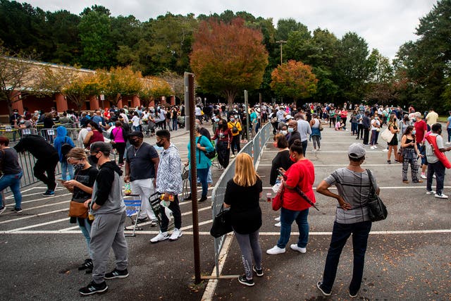 Hundreds of people wait in line for early voting on Monday 12 October 2020, in Marietta, Georgia.