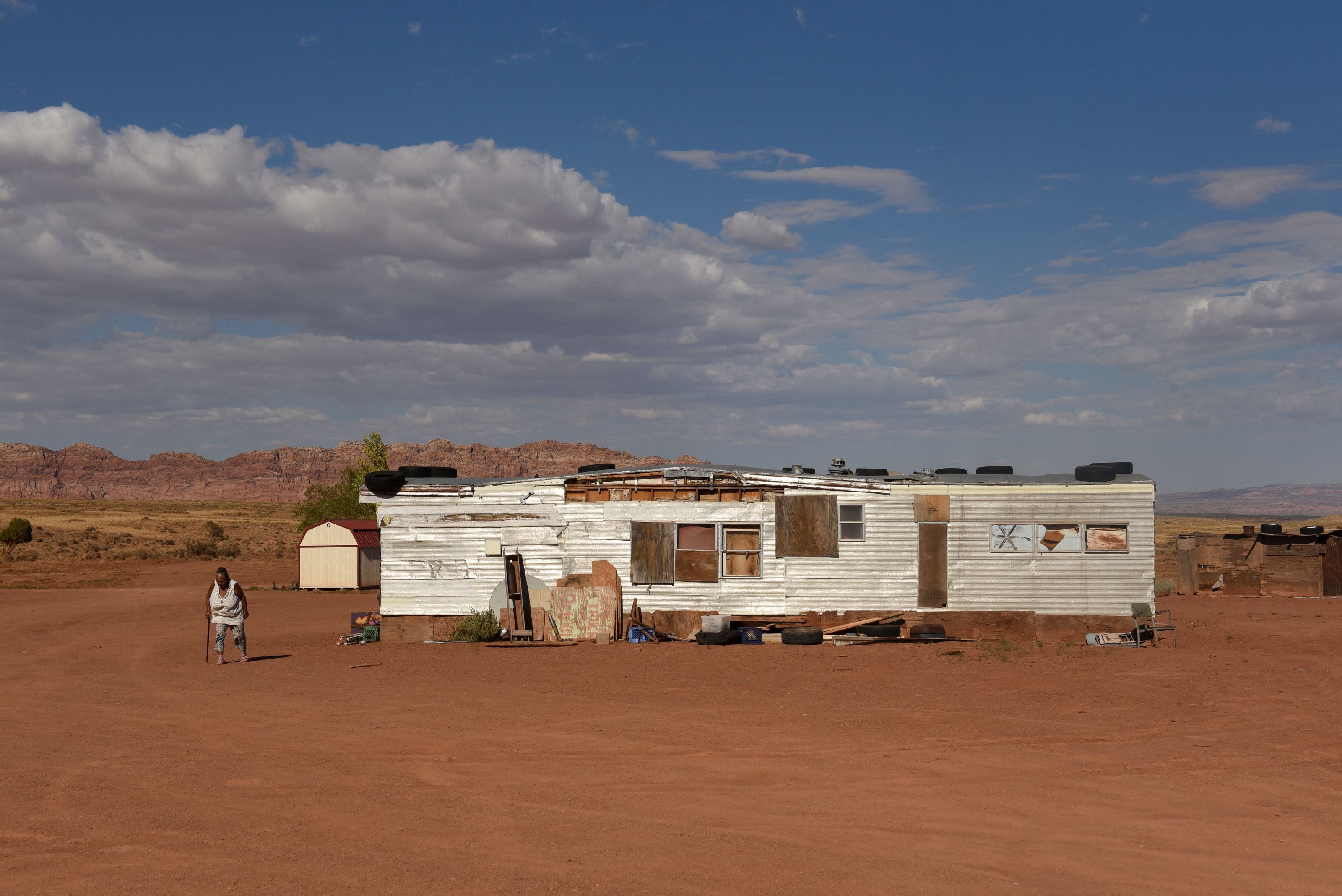 Sarah Begay, 85, walks on her family compound in a remote area