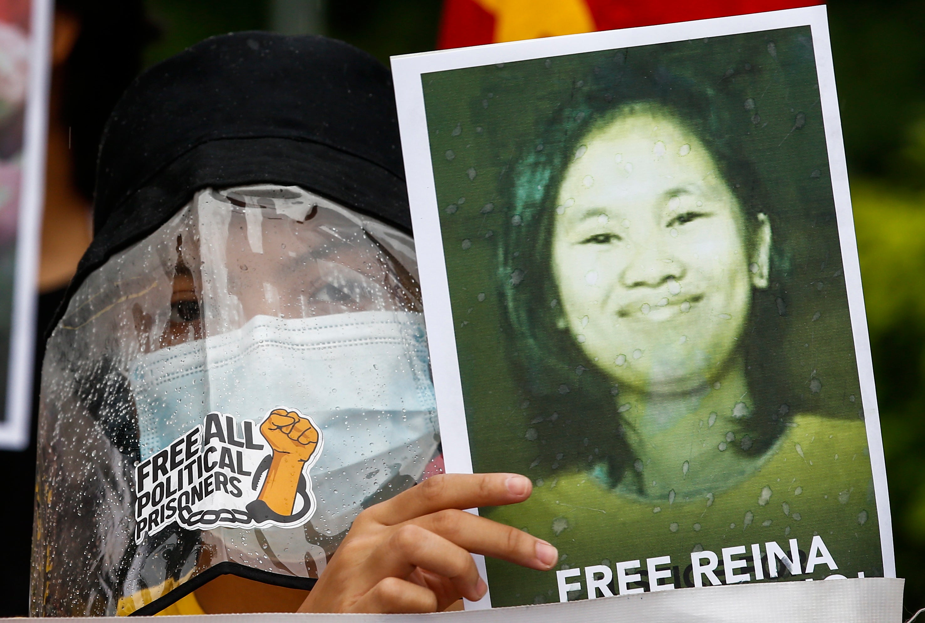 A protester holds a sign calling for the release of jailed human rights advocacy worker Reina Mae Nasino