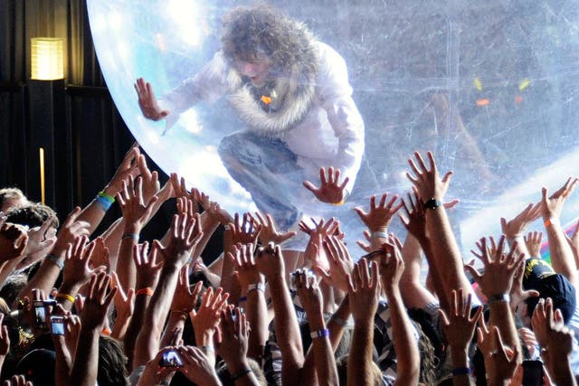 The Flaming Lips performing with a bubble in 2011. Unlike their recent concert, the audience were not given bubbles of their own