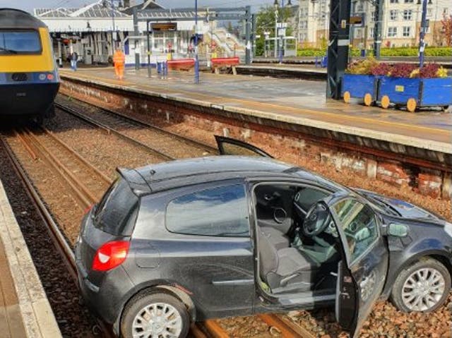 The Renault Clio sits in close proximity to a ScotRail train on the tracks at Stirling station 