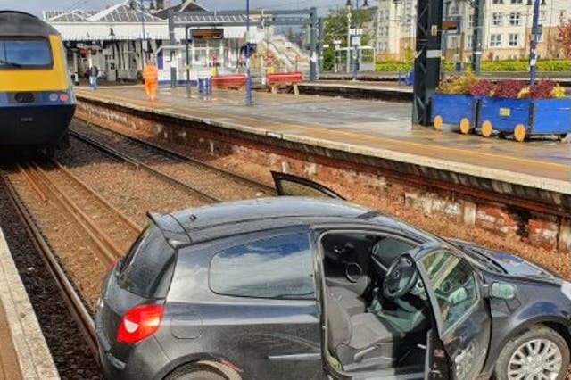 The Renault Clio sits in close proximity to a ScotRail train on the tracks at Stirling station 