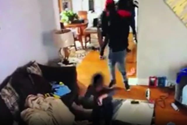 Footage released by police shows a five year old boy trying to protect his mother from armed robbers.