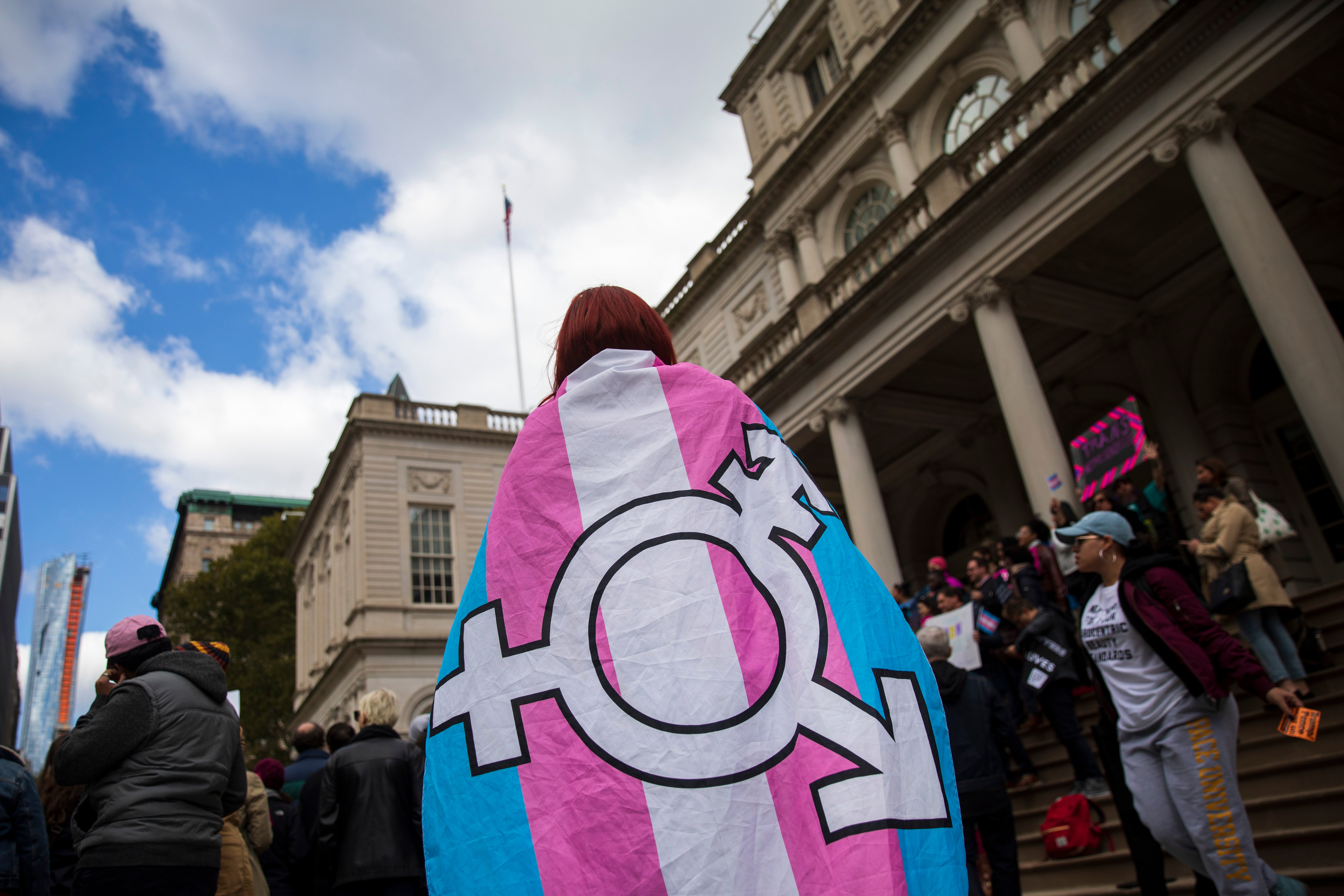 LGBT+ activists and their supporters rally in support of transgender people on the steps of New York City Hall in New York City