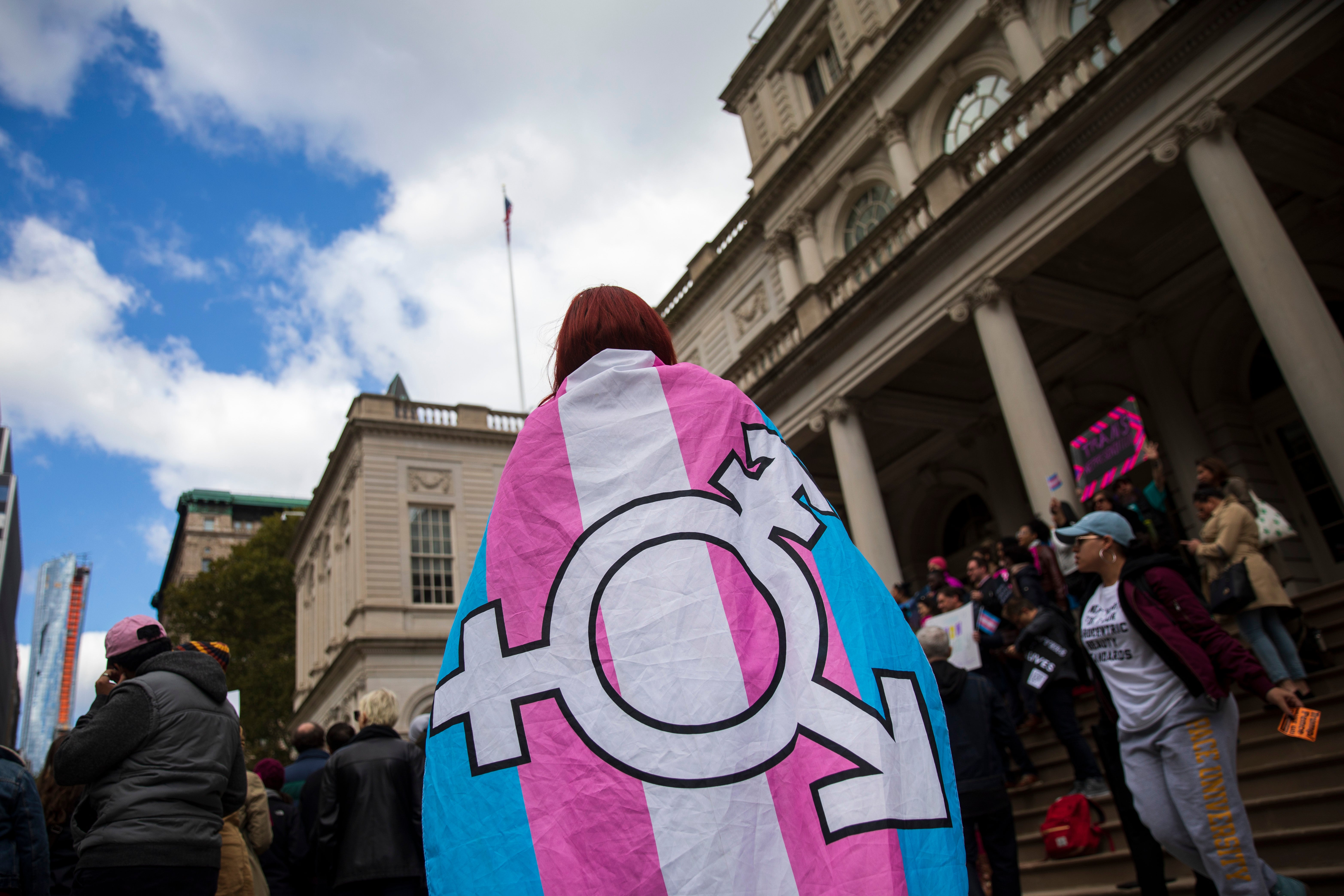 NEW YORK, NY - OCTOBER 24: L.G.B.T. activists and their supporters rally in support of transgender people on the steps of New York City Hall, October 24, 2018 in New York City. The group gathered to speak out against the Trump administration's stance toward transgender people. Last week, The New York Times reported on an unreleased administration memo that proposes a strict biological definition of gender based on a person's genitalia at birth. (Photo by Drew Angerer/Getty Images)