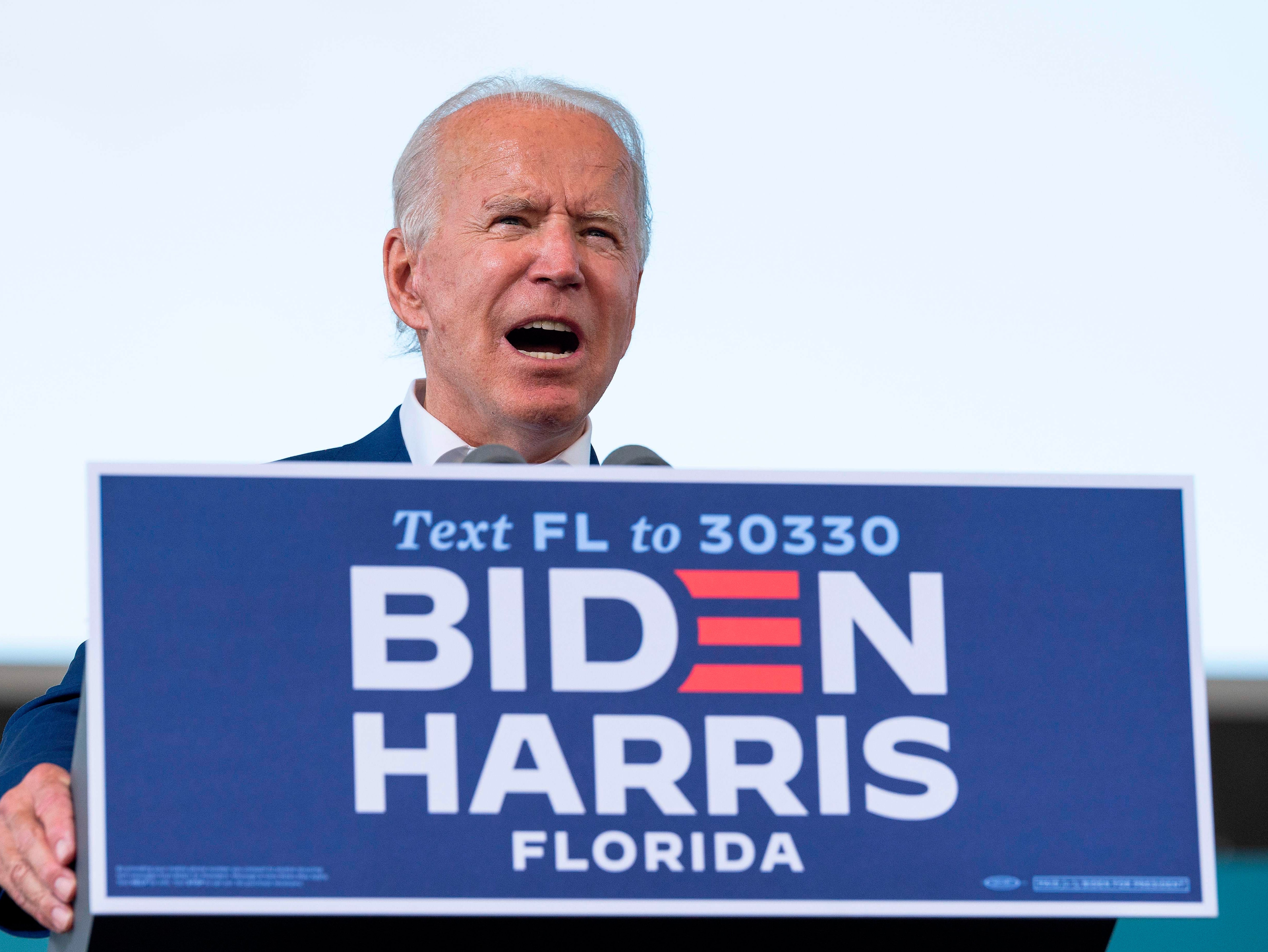 Harris pauses campaign after aide tests positive for Covid - live