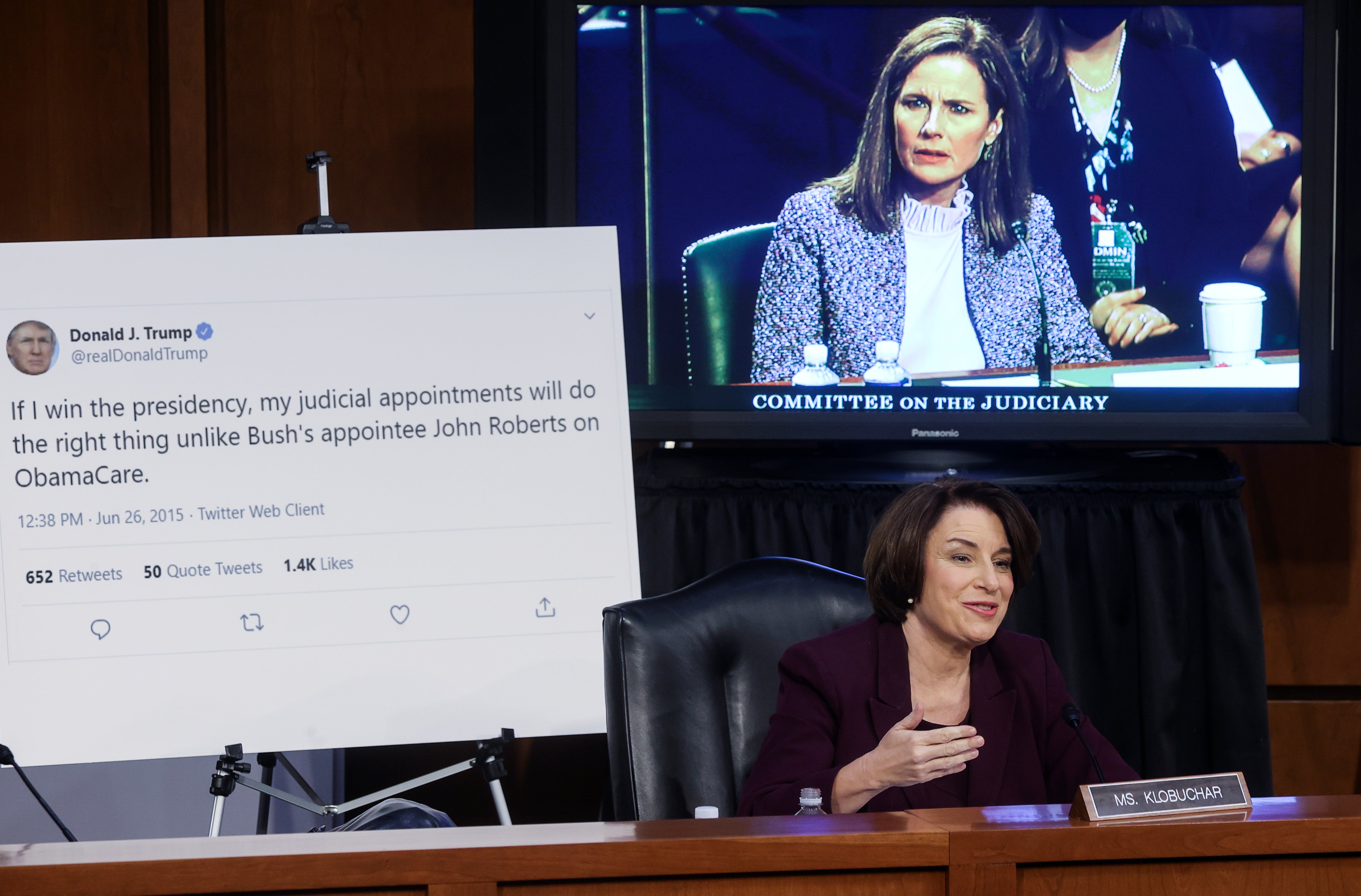 Senator Amy Klobuchar (a Democrat) displays a tweet by Trump as she questions Barrett in a hearing
