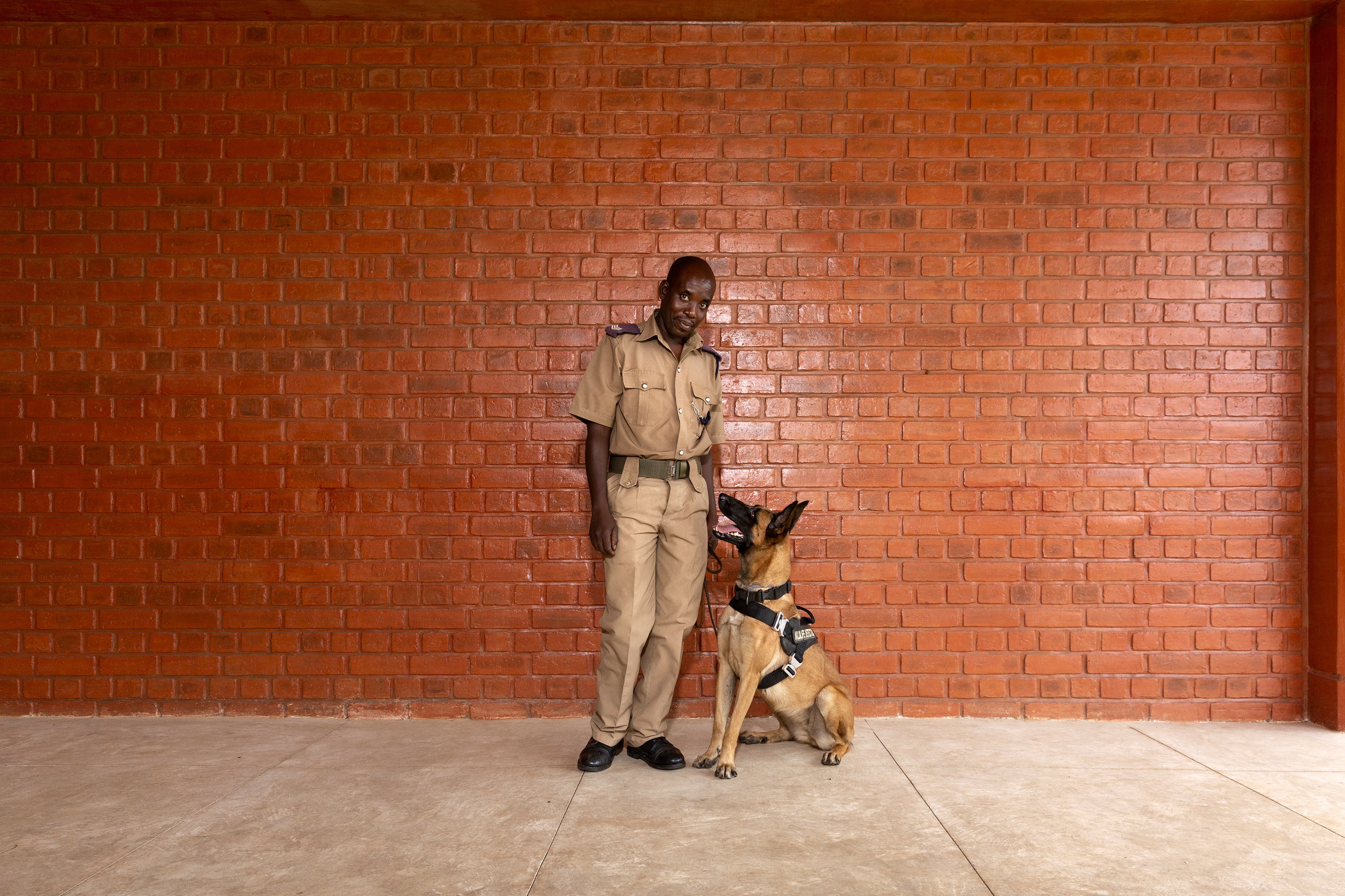 Handler Kinord Makunganya and dog Danna at Malawi’s Kamuzu International Airport