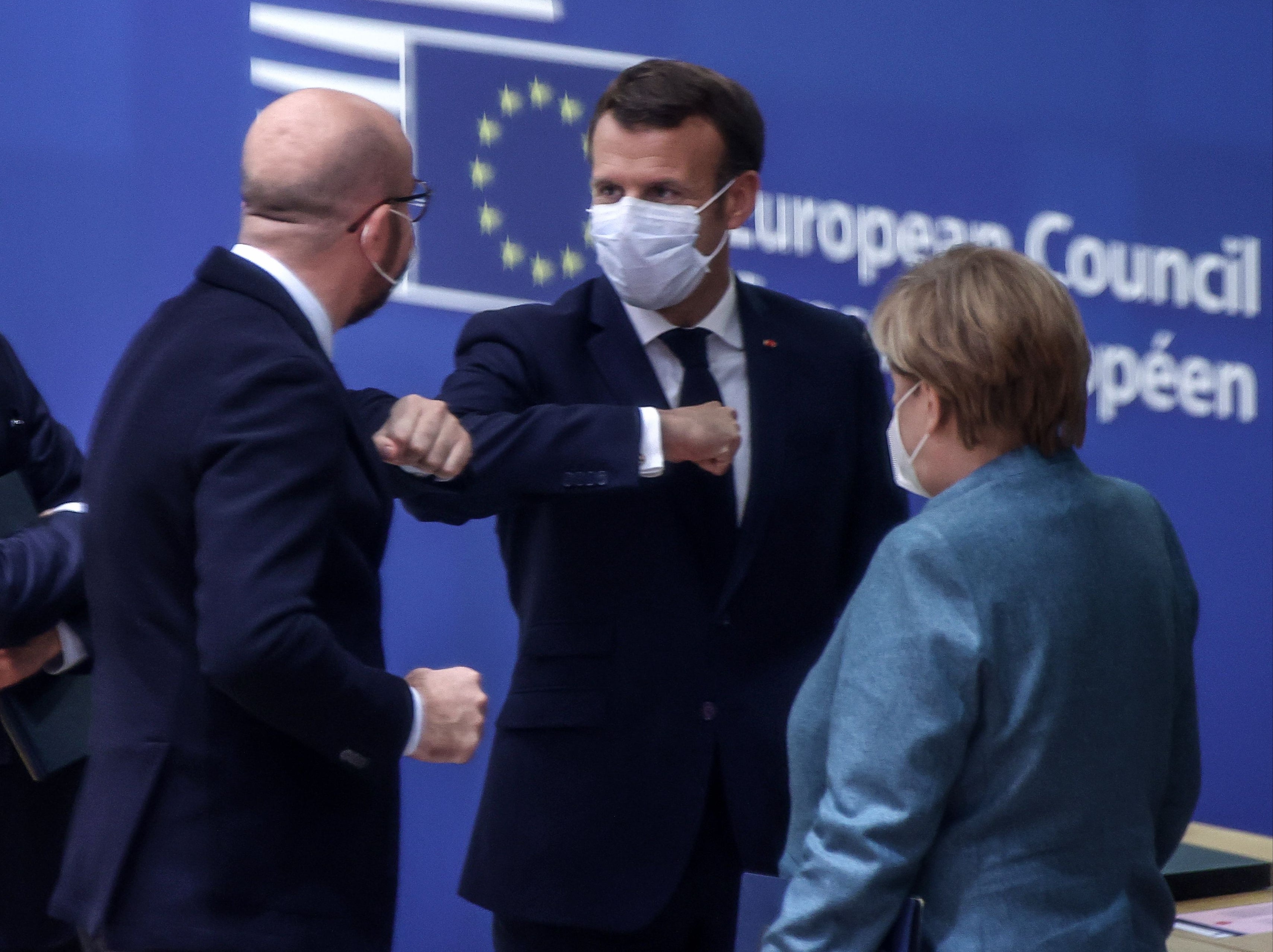 Emmanuel Macron (centre) with EU Council president Charles Michel (left) and German chancellor Angela Merkel (right)