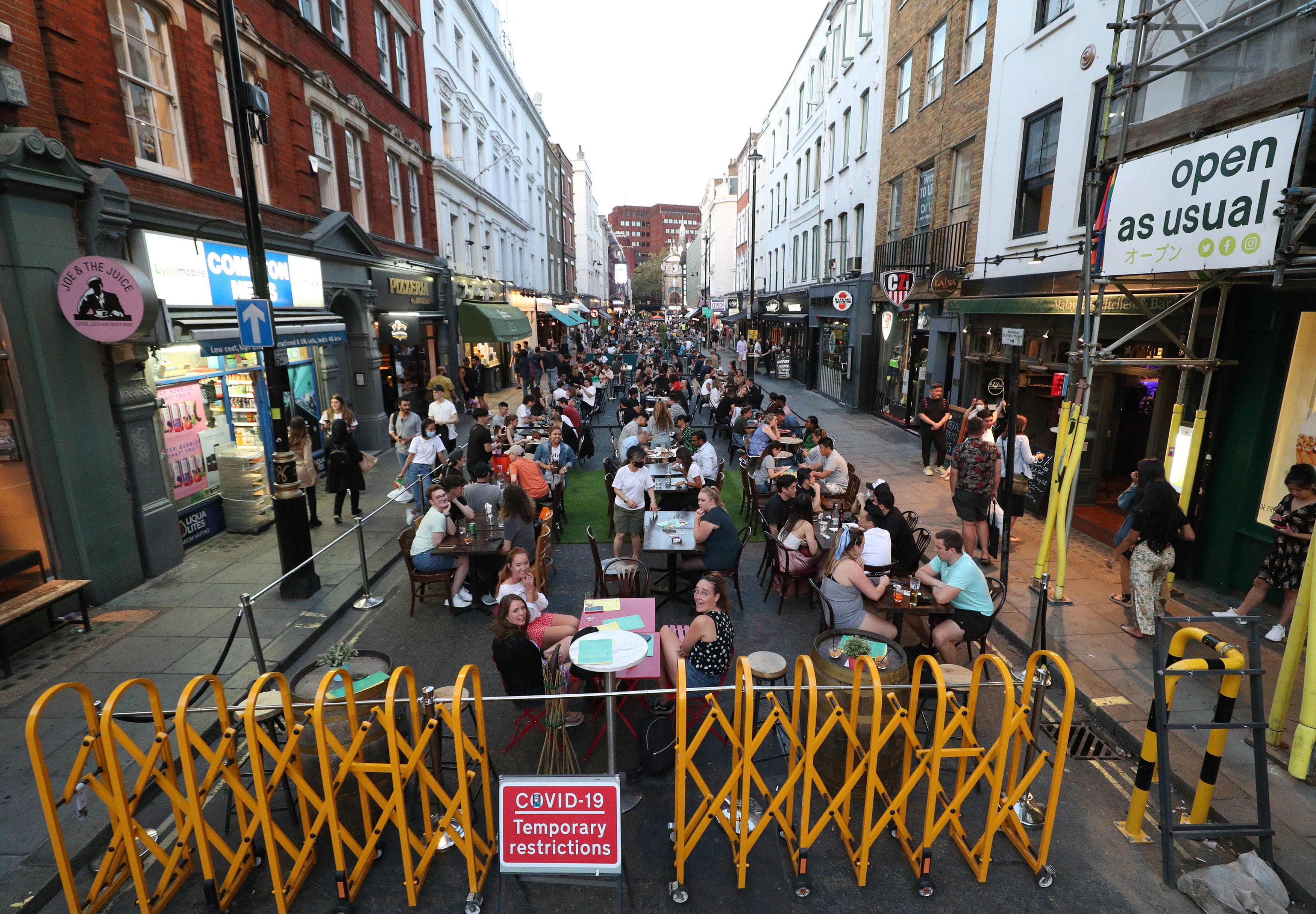 People drinking and dining out in Soho, London, as the Metropolitan Police has said it will deploy resources across the capital to enforce the tighter restrictions on social gatherings