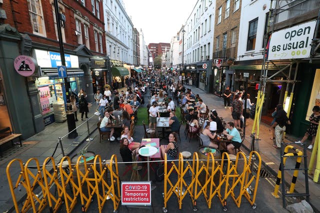 People drinking and dining out in Soho, London, as the Metropolitan Police has said it will deploy resources across the capital to enforce the tighter restrictions on social gatherings