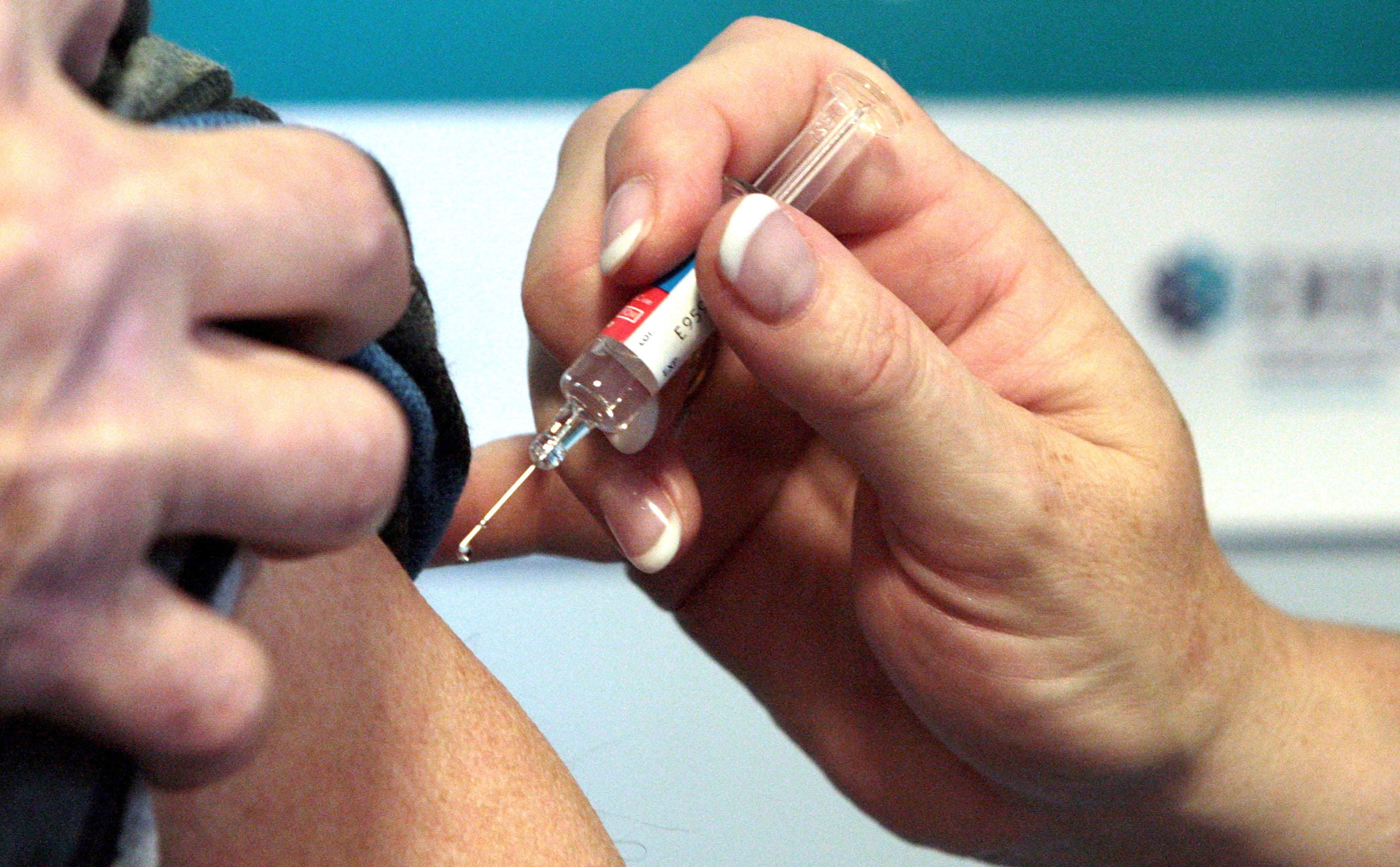 A file photo shows a person receiving a vaccination.