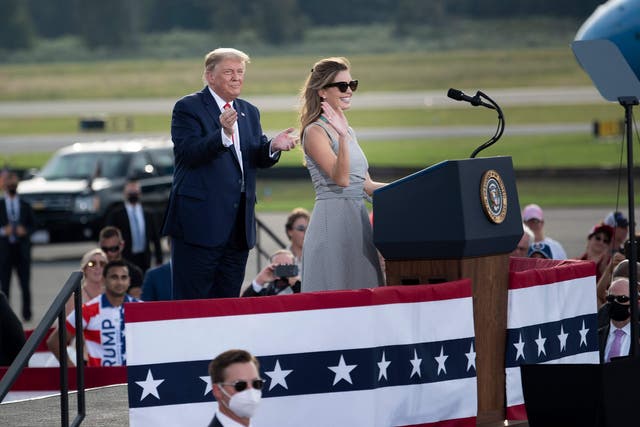 <p>US President Donald Trump listens as aide Hope Hicks speaks during a Make America Great Again rally at Ocala International Airport in Ocala, Florida on October 16, 2020. (Photo by Brendan Smialowski / AFP)&nbsp;</p>