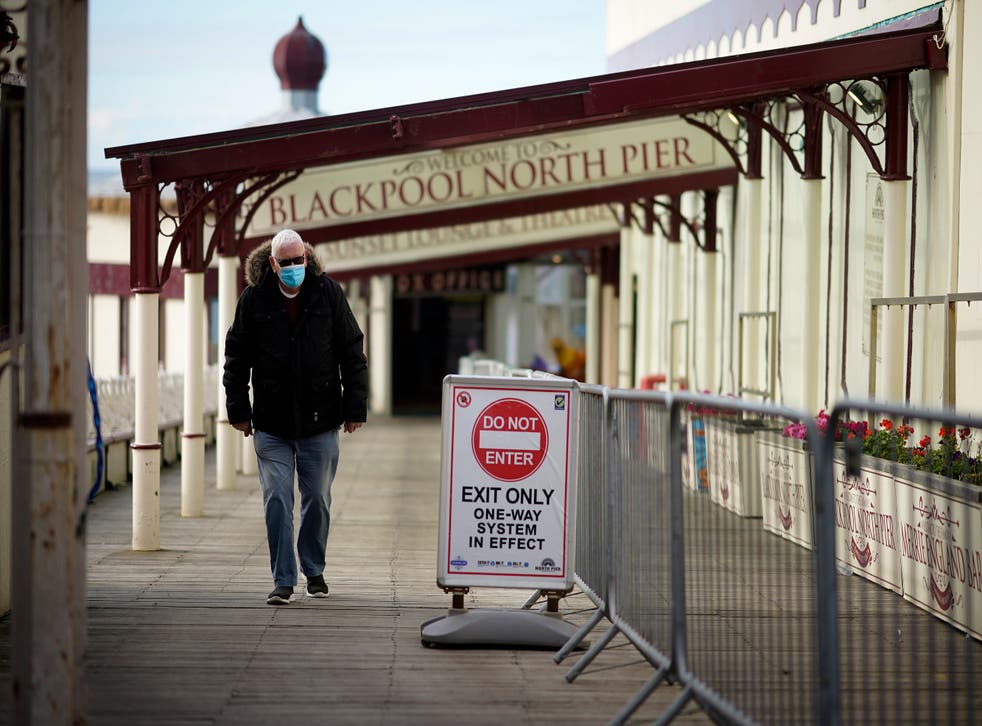 Visitors wear face masks on the promenade in Blackpool, England