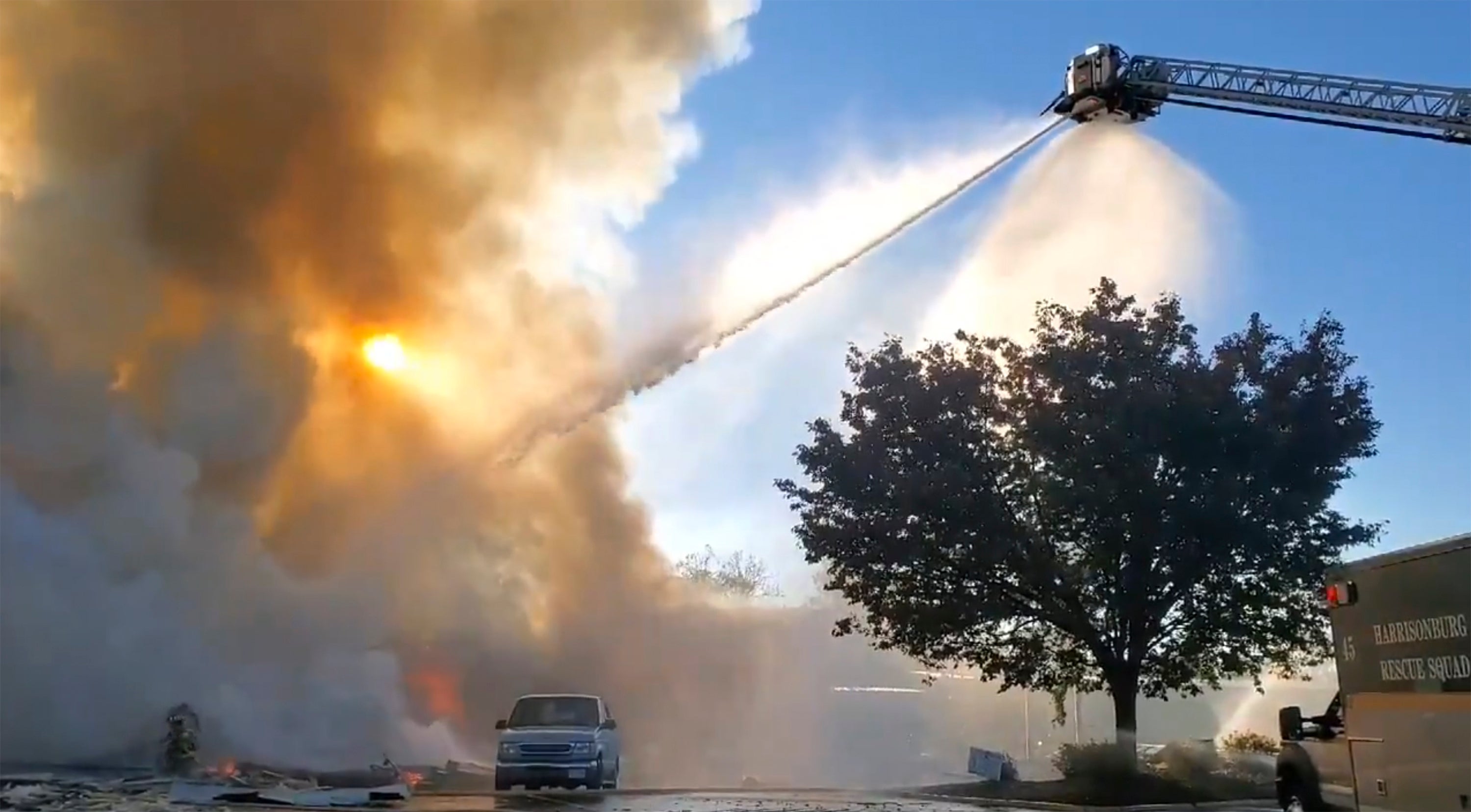 Firefighters battled a three-alarm blaze after reports of an explosion at a a shopping centre in Harrisonburg, Virginia on 17 October.