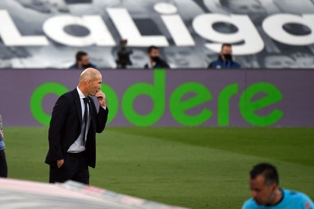 Zinedine Zidane watches on from the touchline