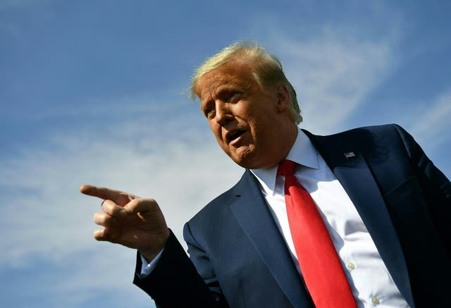 US President Donald Trump speaks to members of the media upon arrival at Phoenix Sky Harbor International Airport in Phoenix, Arizona on October 19, 2020. Trump is heading to Prescott, Arizona for a campaign rally. - US President Donald Trump went after top government scientist Anthony Fauci in a call with campaign staffers on October 19, 2020, suggesting the hugely respected and popular doctor was an "idiot." (Photo by MANDEL NGAN / AFP) (Photo by MANDEL NGAN/AFP via Getty Images)