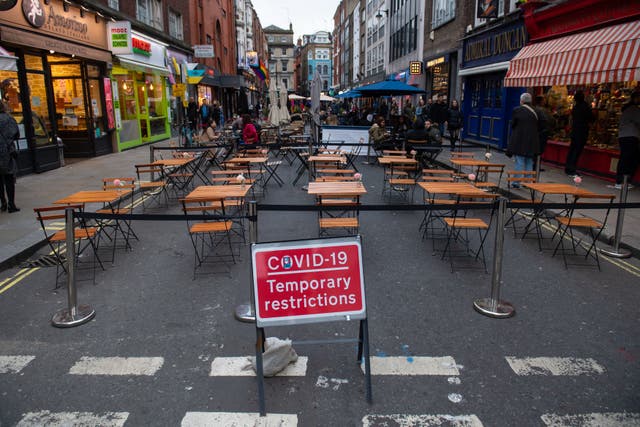 Covid 19 signage in Soho, London, on the first day after the city was put into Tier 2 restrictions to curb the spread of coronavirus