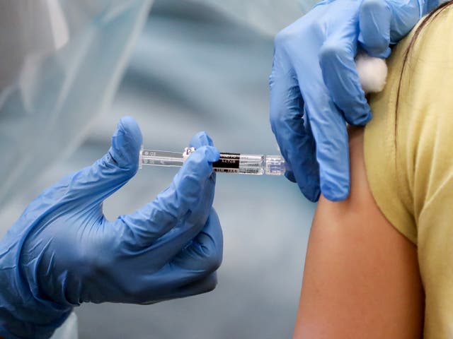 <p>A nurse administering a vaccine </p>