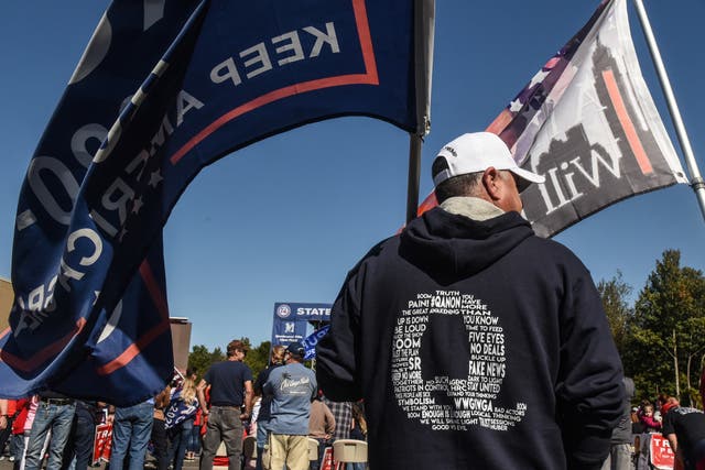 Supporters of Donald Trump wear QAnon branded clothes at rally 