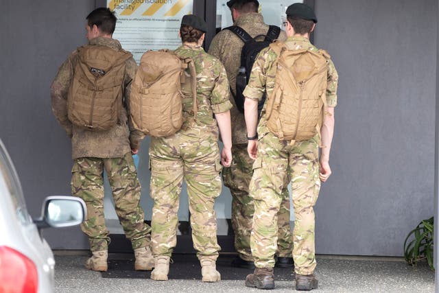 Military personnel arrive at the Sudima Hotel in Christchurch, New Zealand, after fishermen tested positive for Covid