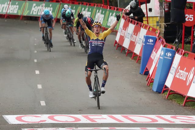 Primoz Roglic celebrates as he crosses the line to win stage one
